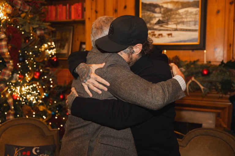 This photo provided by the office of Tennessee Gov. Bill Lee shows Gov. Bill Lee, left, hugs country musician Jelly Roll on Thursday, Dec. 18, 2025, at the Tennessee Governor's Mansion in Oak Hill, Tenn.