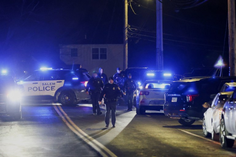 Law enforcement officers search the area for the Brown University shooting suspect,