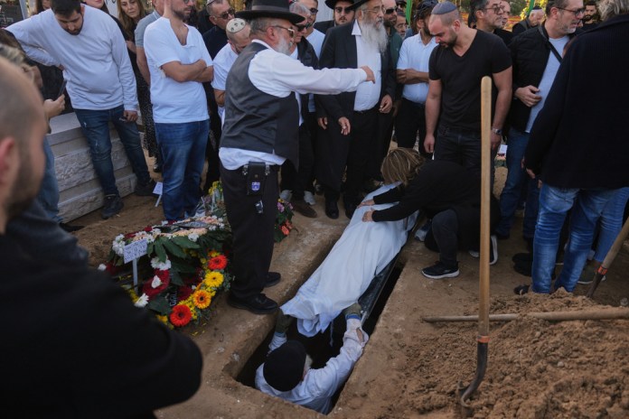 Annie mourns over the body of her son Dan Elkayam, a young French Jewish man who was killed in the mass shooting that targeted a Hanukkah celebration on Sydney's Bondi Beach in Australia, during his funeral in Ashdod, Israel, Thursday, Dec. 25, 2025.