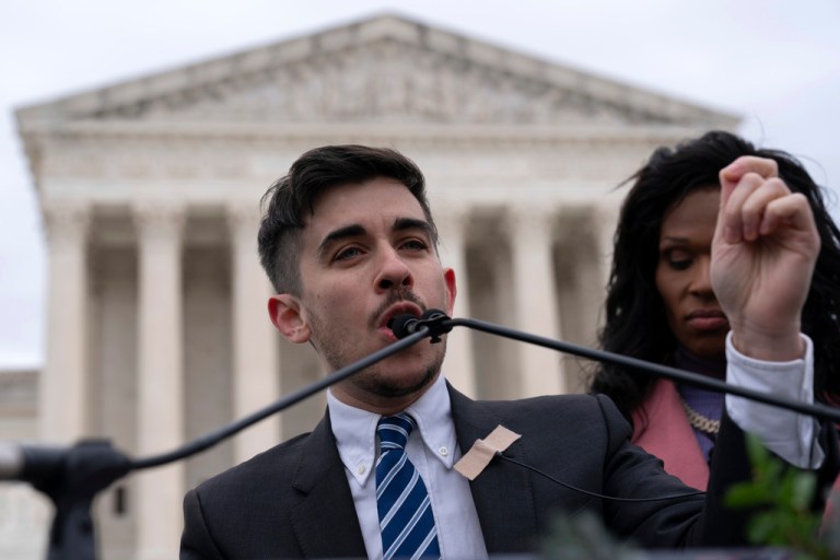 Attorney and transgender rights activist Chase Strangio speaks to supporters outside of the Supreme Court.