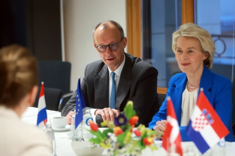 European Commission President Ursula von der Leyen, right, and Germany's Chancellor Friedrich Merz, left, attend a roundtable meeting on migration at the EU Summit in Brussels.