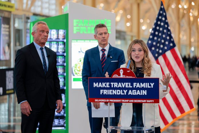 Influencer and mom Isabel Brown speaks alongside U.S. Transportation Secretary Sean P. Duffy (C) and Human Services Secretary Robert F. Kennedy Jr. during the press conference for the launch of the "Make Travel Family Friendly Again" campaign at Washington National Airport on December 08, 2025 in Arlington, Virginia. The campaign's focus is to incentivize more family-friendly resources (Photo by Heather Diehl/Getty Images)