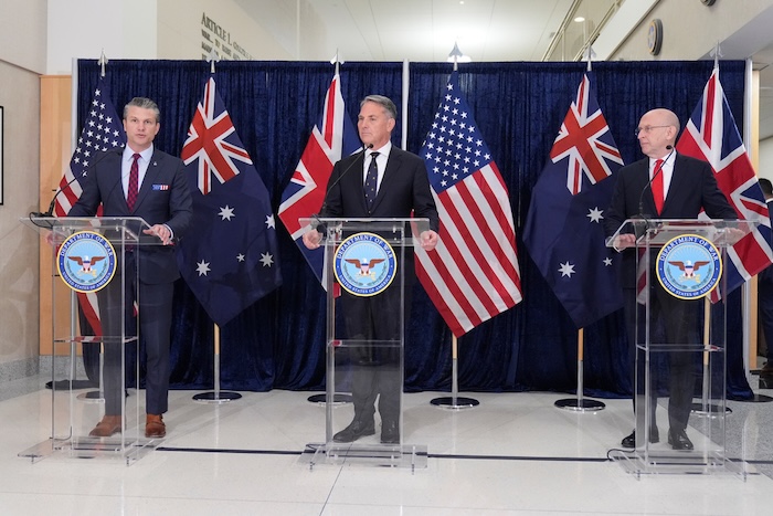 From left, Secretary of Defense Pete Hegseth, Australia's Deputy Prime Minster and Defense Minister Richard Marles, and Britain's Defense Secretary John Healey attend the AUKUS Defense Minister's Ministerial meeting at the Pentagon, Wednesday, Dec. 10, 2025, in Washington. (AP Photo/Mark Schiefelbein)