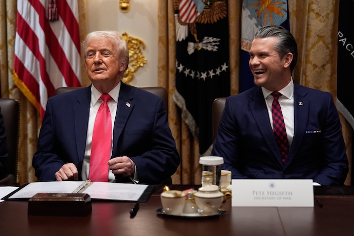 President Donald Trump speaks during a cabinet meeting at the White House, Tuesday, Dec. 2, 2025, in Washington, as Defense Secretary Pete Hegseth looks on. (AP Photo/Julia Demaree Nikhinson)