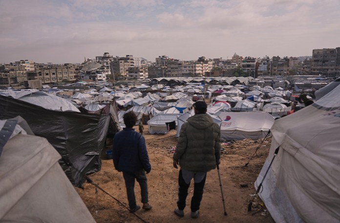Palestinians look over makeshift tents of a camp for displaced people in an area of Gaza City on Dec. 29, 2025. (Jehad Alshrafi/AP)