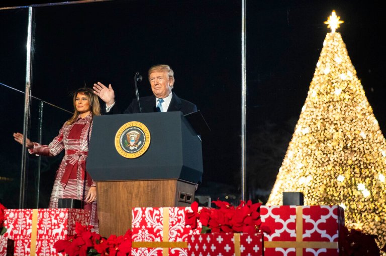 President Donald Trump and first lady Melania Trump wave during the National Christmas Tree Lighting ceremony.