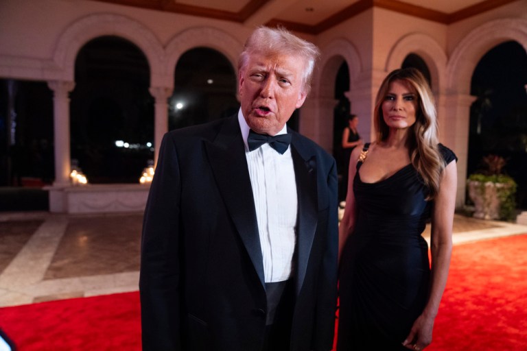Melania Trump looks on as President-elect Donald Trump speaks to reporters before a New Year's Eve party at Mar-a-Lago, Tuesday, Dec. 31, 2024, in Palm Beach, Fla.