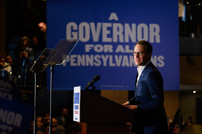 Pennsylvania Governor Josh Shapiro stands behind a podium on stage while announcing his run for a second term on Thursday, Jan. 8, 2026 at the Carpenters Union Local 432 in Pittsburgh.