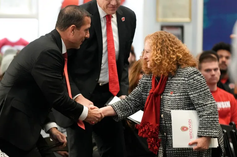 Wisconsin new head football coach Luke Fickell shakes hands with Wisconsin Chancellor Jennifer Mnookin after being introduced Monday, Nov. 28, 2022, in Madison, Wis.