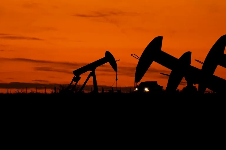 File - A truck passes oil pump jacks at dusk near Karnes City, Texas, Nov. 1, 2023. On Wednesday, the Labor Department releases producer prices data for November. The producer price index is an indicator measuring inflation at the wholesale level, hitting businesses before they pass costs along to consumers.
