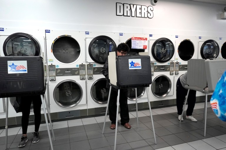 Voters cast their ballots on Election Day at Su Nueva Lavanderia in Chicago.