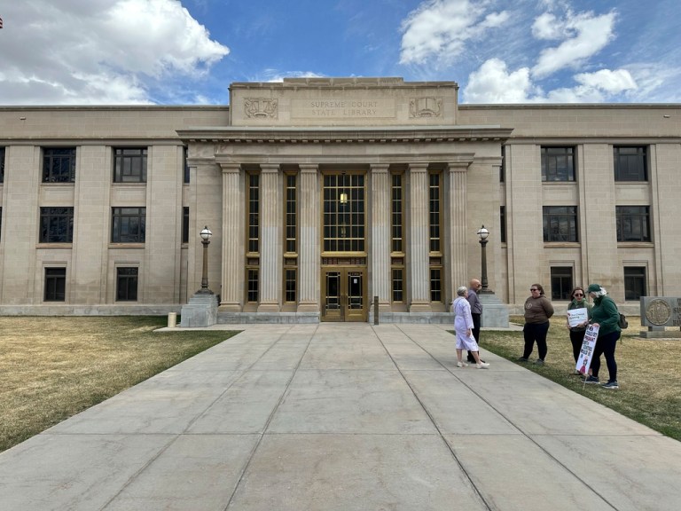 Demonstrators stand before the Wyoming Supreme Court building in Cheyenne ahead of arguments over the state's abortion bans Wednesday, April 16, 2025.