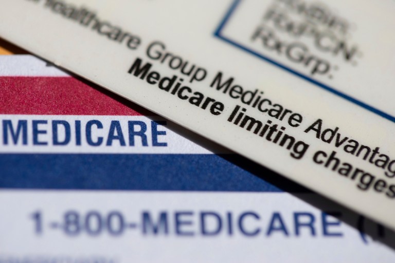 A Medicare Advantage PPO card rests on top of a Medicare card.