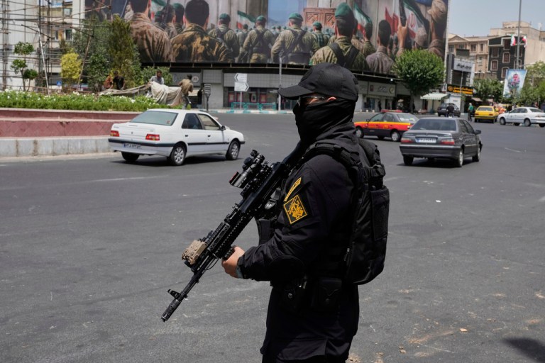 A member of Iran's Revolutionary Guard stands guard at Enqelab-e-Eslami (Islamic Revolution) square in downtown Tehran, Iran, Tuesday, June 24, 2025. (AP Photo/Vahid Salemi, File)
