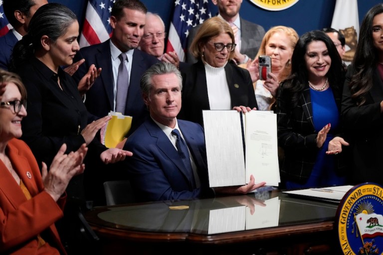 Gov. Gavin Newsom (D-CA) signs legislation.
