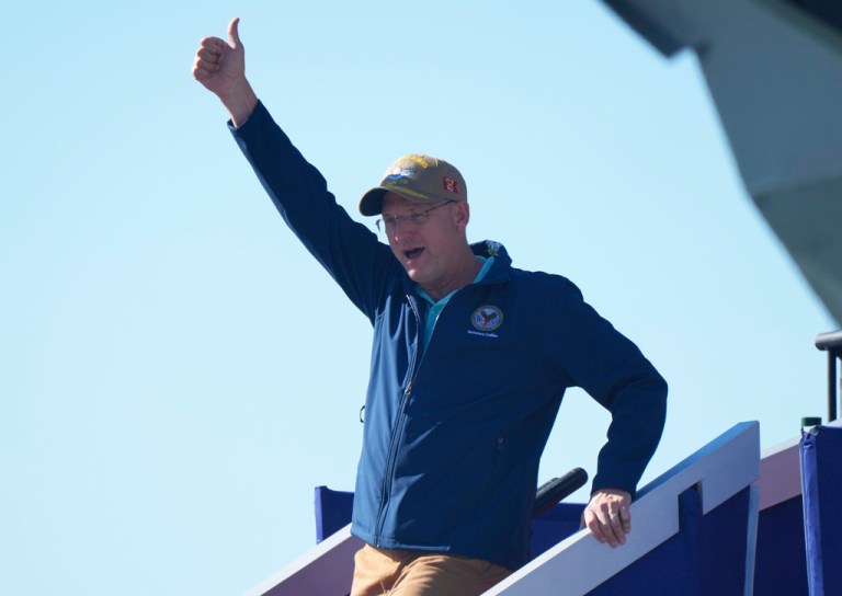 Secretary of Veterans Affairs, Douglas A. Collins walks down the gangway during the Navy 250 A Salute to the Fleet at Naval Station Norfolk, Sunday Oct. 5, 2025 in Norfolk, Va. (AP Photo/Steve Helber)