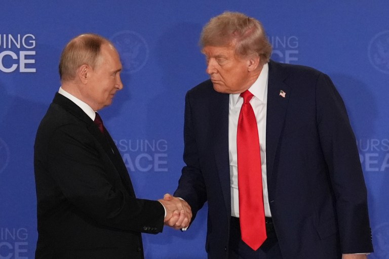 President Donald Trump shakes the hand of Russia's President Vladimir Putin.