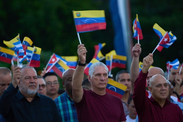 Miguel Diaz-Canel waves a flag at a rally in Havana.