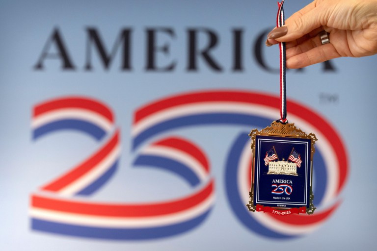 Jennifer Condon, executive vice president of America250, displays the front of a commemorative ornament released by America250 as part of events leading up to the 250th anniversary of the signing of the Declaration of Independence.