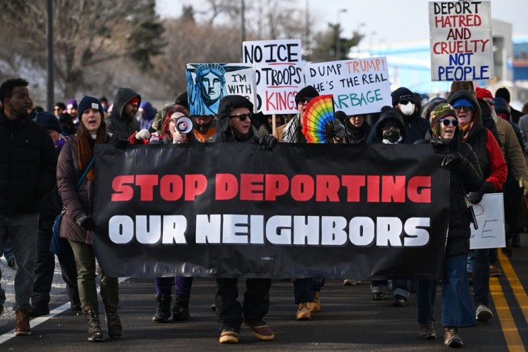 Protesters gather at a rally for immigrants and workers outside Signature Aviation near the Minneapolis–Saint Paul International Airport, Wednesday, Dec 3, 2025, in Minneapolis. (AP Photo/Tom Baker)