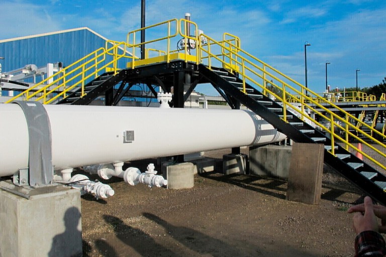 FILE - An above-ground section of Enbridge's Line 5 is seen at the Mackinaw City, Mich., pump station, Oct. 7, 2016. (AP Photo/John Flesher, File)