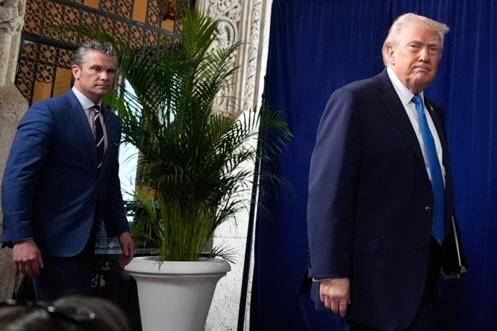 President Donald Trump arrives to speak at his Mar-a-Lago club, Saturday, Jan. 3, 2026, in Palm Beach, Fla., with Defense Secretary Pete Hegseth.