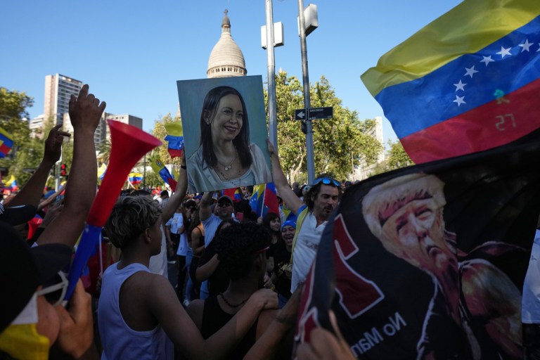 Venezuelans celebrate with a painting depicting opposition leader and Nobel Peace Prize winner Maria Corina Machado in Santiago, Chile.