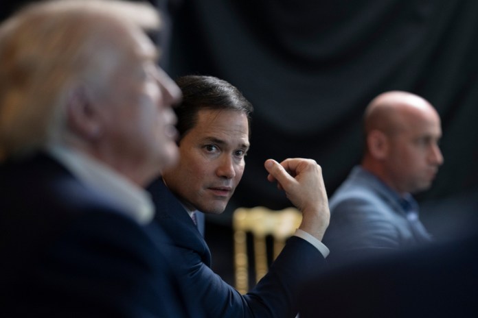 In this photo released by the White House, President Donald Trump monitors U.S. military operations in Venezuela,
