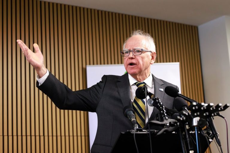 Minnesota Gov. Tim Walz responds to questions from reporters regarding whether he will seek a third term