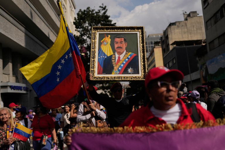 Maduro supporters carry a ceremonial picture of the president in Venezuela