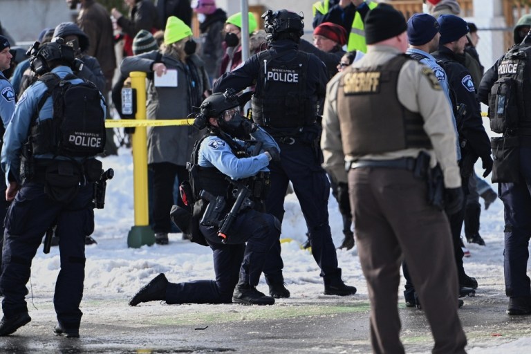 Law enforcement officers attend to the scene of the shooting involving federal law enforcement agents, Wednesday, Jan. 7, 2026, in Minneapolis.