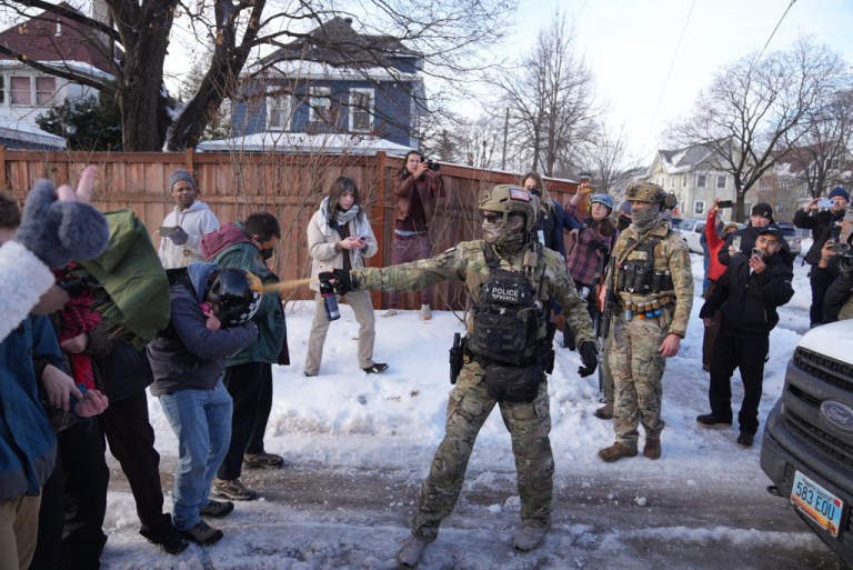A law enforcement agent sprays a line of protestors with chemical spray scene of a shooting in Minneapolis, on Wednesday, Jan. 7, 2026. (Alex Kormann/Star Tribune via AP)