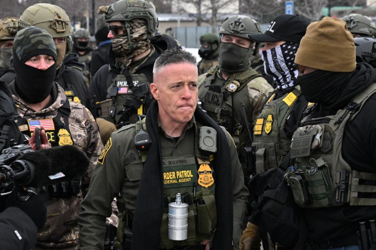 U.S. Border Patrol Cmdr. Gregory Bovino arrives as protesters gather outside the Bishop Henry Whipple Federal Building.