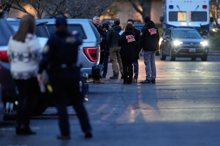 Law enforcement officials work the scene following reports that federal immigration officers shot and wounded people in Portland