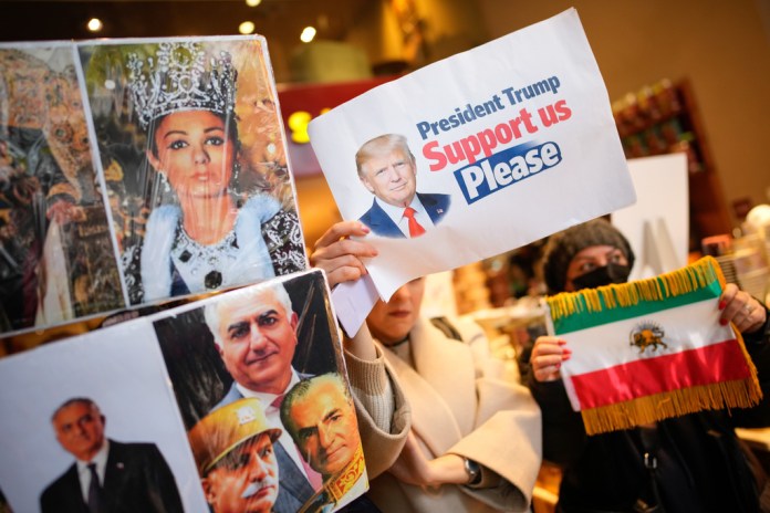People hold up photos of Reza Pahlavi, the son of Iran's toppled Shah Mohammad Reza Pahlavi, during a small demonstration in Istanbul.