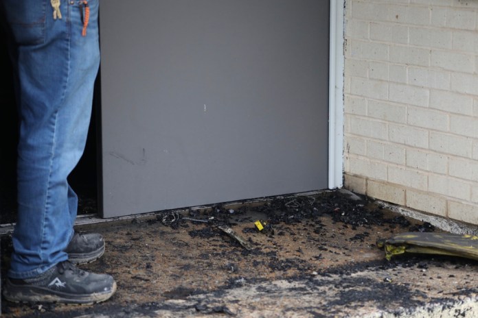 Zach Shemper, president of Beth Israel Congregation, stands in ashes outside the congregation’s temple hours after the building was damaged by fire Saturday, Jan. 10, 2026 in Jackson, Miss. (Allen Siegler/Mississippi Today via AP)