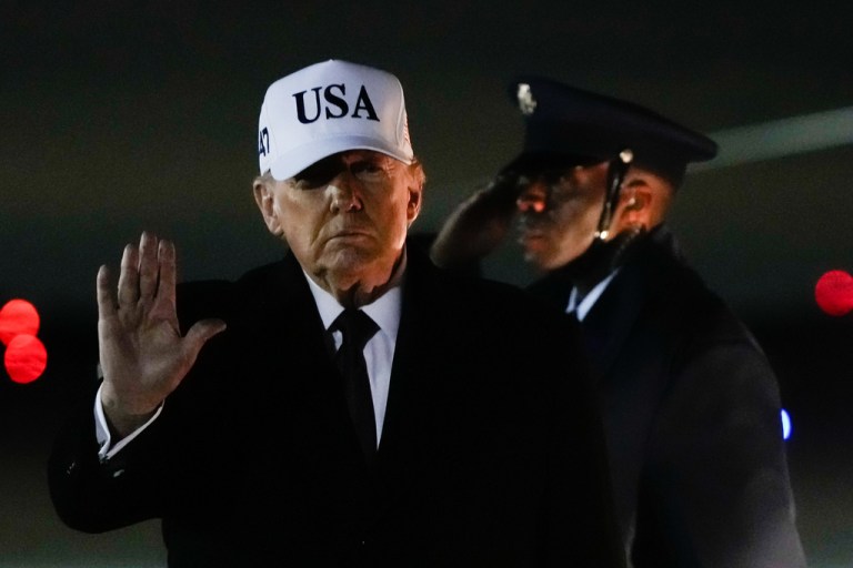 President Donald Trump waves outside.
