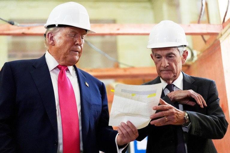 FILE - Federal Reserve Chairman Jerome Powell, right, and President Donald Trump look over a document of cost figures during a visit to the Federal Reserve, July 24, 2025, in Washington. (AP Photo/Julia Demaree Nikhinson, File)