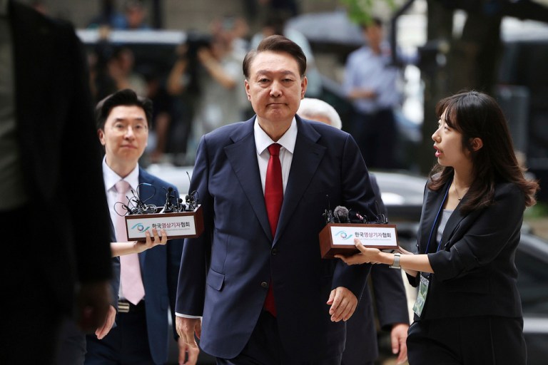 Former South Korean President Yoon Suk Yeol, center, arrives at a court to attend a hearing to review his arrest warrant requested by special prosecutors in Seoul, South Korea, July 9, 2025.