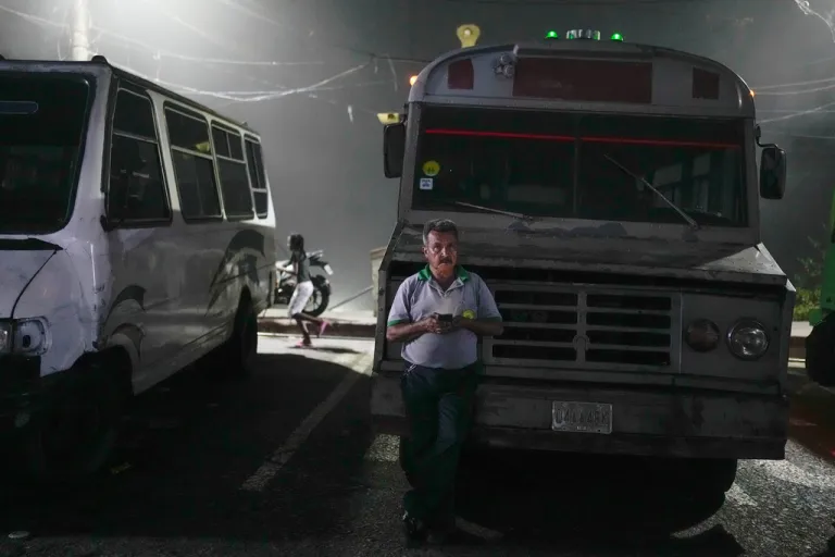 A bus driver waits to depart from the Catia neighborhood of Caracas, Venezuela