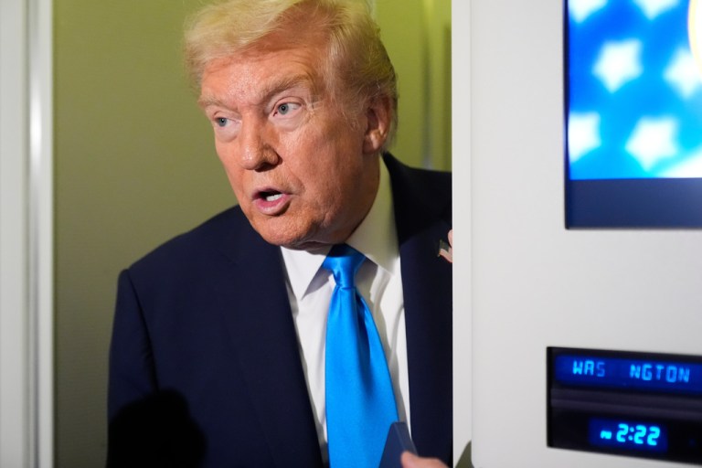 President Donald Trump speaks aboard Air Force One.