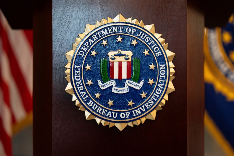 An FBI insignia is displayed on a podium before a news conference at the field office in Portland, Ore., Jan. 16, 2025.