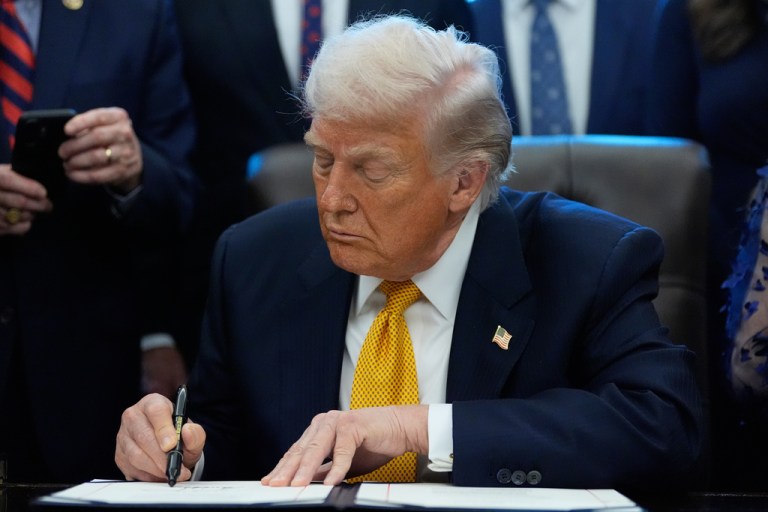 President Donald Trump signs a bill that returns whole milk to school cafeterias across the country, in the Oval Office of the White House, Wednesday, Jan. 14, 2026.