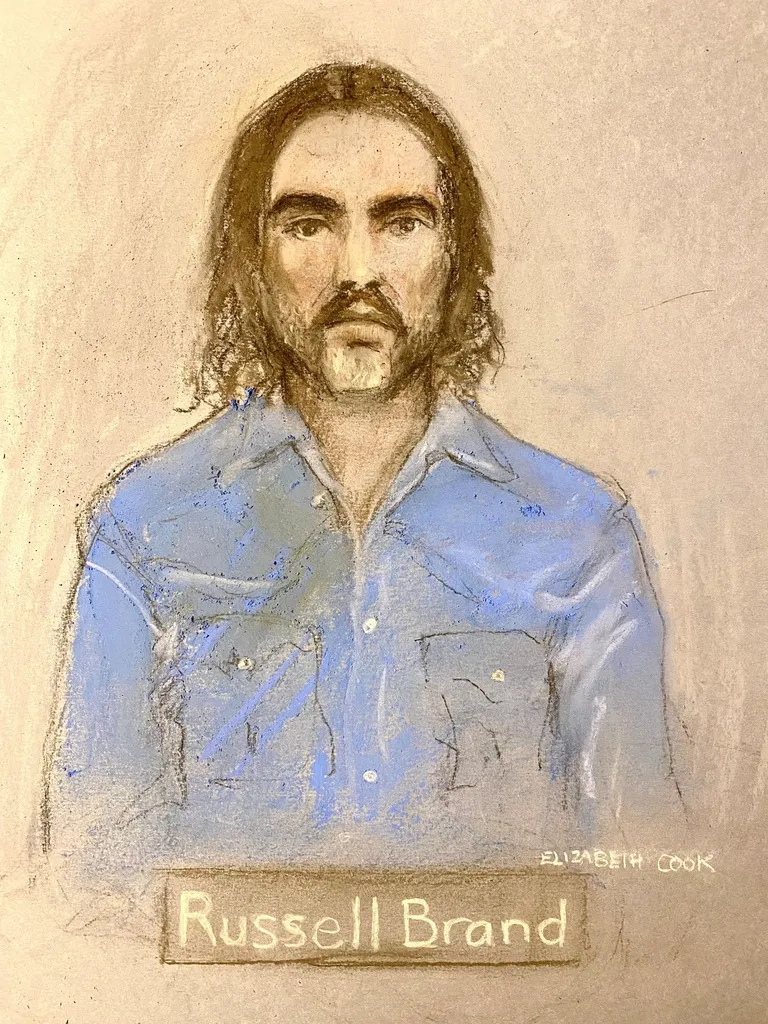 Court artist sketch by Elizabeth Cook of Russell Brand appearing via video link at Westminster Magistrates' Court, central London, Tuesday, Jan. 20, 2026. (Elizabeth Cook/PA via AP)