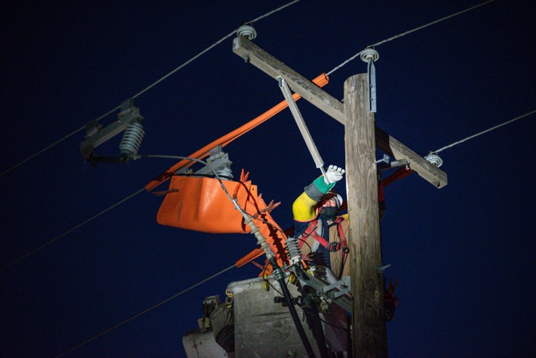 Oncor apprentice lineman Brendan Waldon repairs a utility pole that was damaged by a winter storm.