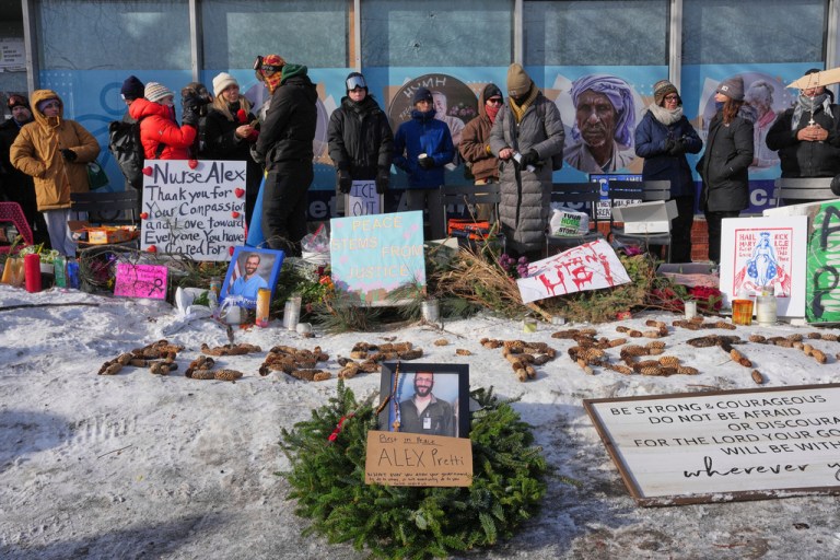 People gather near the scene where Alex Pretti was fatally shot by a Border Patrol agent yesterday in Minneapolis.
