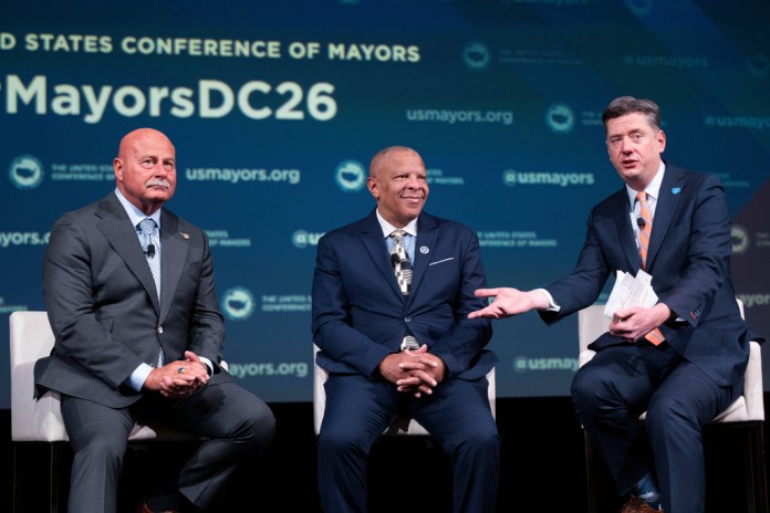 Oklahoma City Mayor David Holt, right, speaks during a panel discussion with Fresno, California, Mayor Jerry Dyer, left, and Omaha, Nebraska, Mayor John Ewing, Jr. during the 94th Winter Meeting of the U.S. Conference of Mayors.