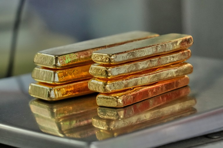 A gold jeweler weighs gold bars for sale in Bangkok, Thailand, Thursday, Jan. 29, 2026.