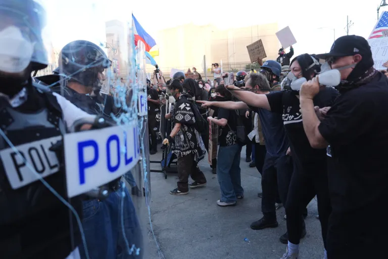 Protesters face off against police at the Metropolitan Detention Centerin downtown Los Angeles on Friday, Jan. 30,2026.