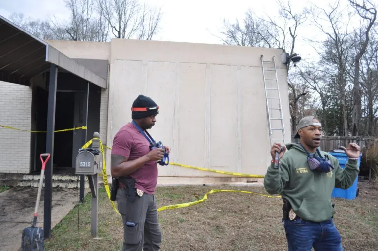 Firefighters Dwight Jones and Anthony Byrd investigate a fire that broke out hours earlier at Beth Israel Congregation synagogue in Jackson, Mississippi.